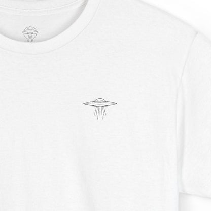White t-shirt with a small ufo logo on a white background