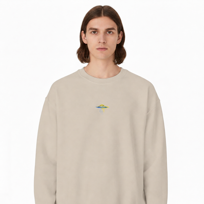 Model wearing colorful UFO embroidered at center chest on sand crewneck sweatshirt